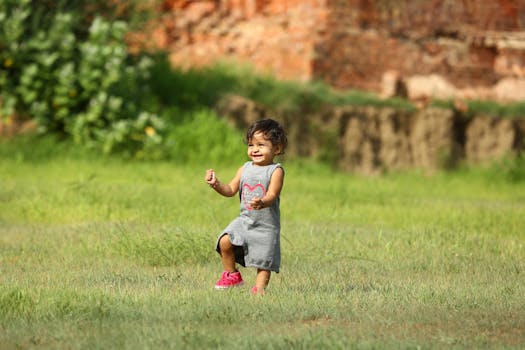 A happy child playing on a grassy field, embodying joy and innocence on a bright sunny day.